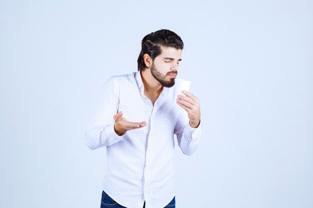 Man holding and promoting a coffee cup or coffee