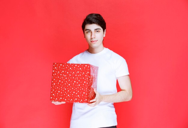 Man holding a red big gift box