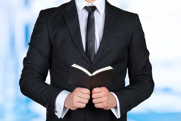 A man holding a schedule book