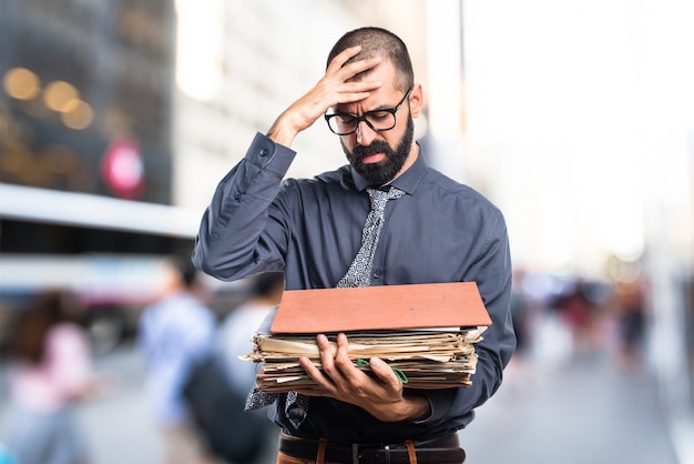 Free photo man holding several college notes