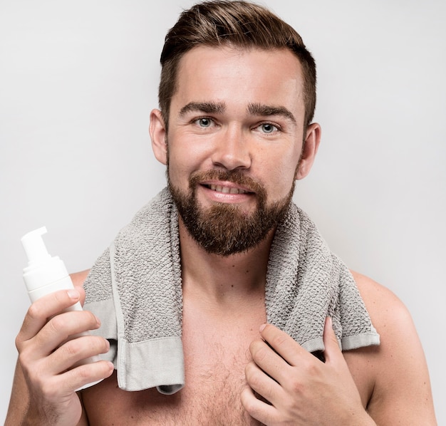 Man holding a shaving cream bottle