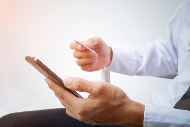 Man holding smart phone and credit card. Shopping Online