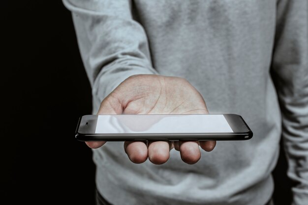 Man holding smartphone with a white screen