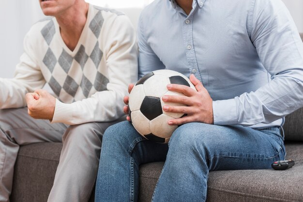 Man holding a soccer ball with hands
