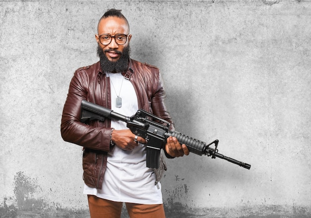 Free photo man holding a submachine gun