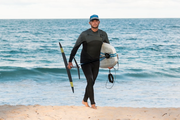 Man holding a surfing board outdoors