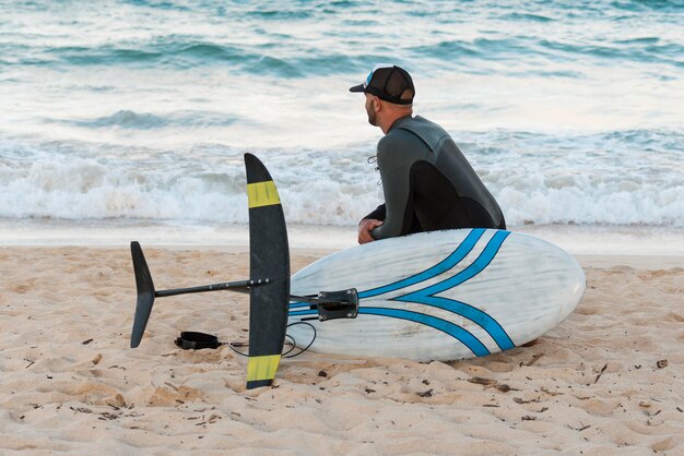 Man holding a surfing board outdoors