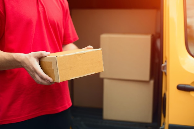 Man holding tan cardboard box