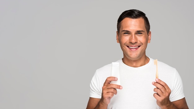 Man holding toothbrush and toothpaste