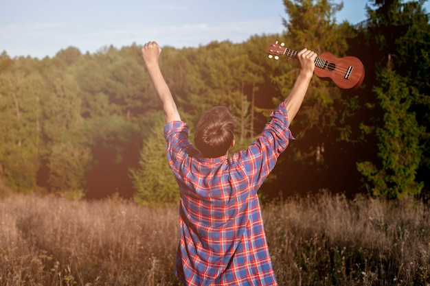 Man holding ukulele in the air