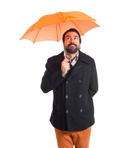 Man holding an umbrella over white background