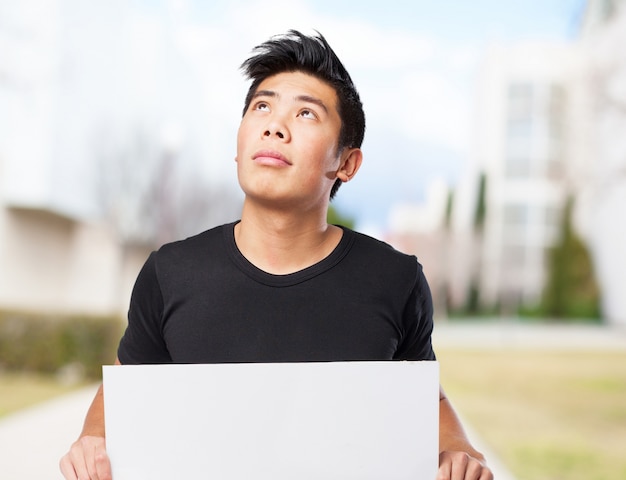 Man holding a white poster