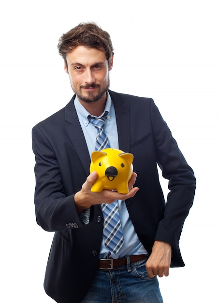 Free photo man holding a yellow pig piggy bank