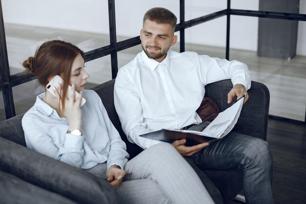 Man holds a folder. Business partners at a business meeting.Woman talking on the phone