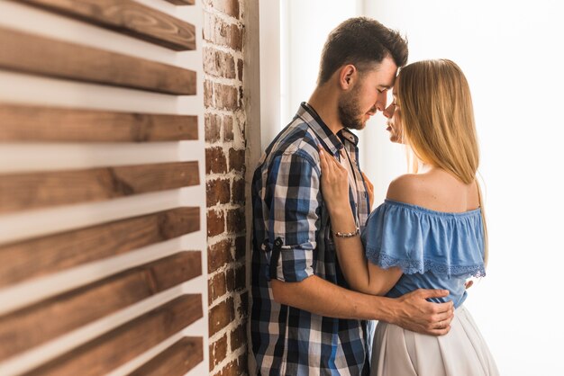 Man holing his girlfriend waits at home