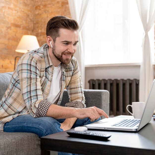 Man at home having videocall with family