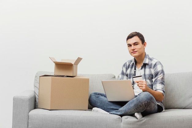 Man at home with packaging boxes