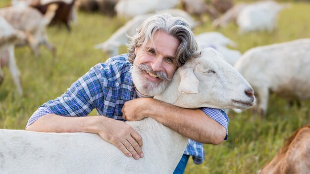 Man hugging goat