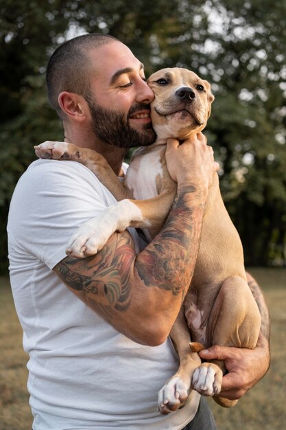 Man hugging his friendly pitbull