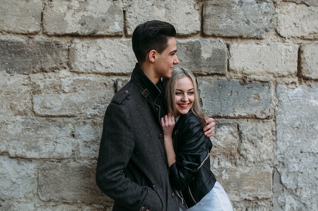 Man hugging his girlfriend on the street