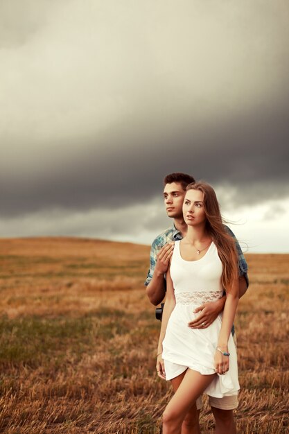 Man hugging his partner on a cloudy day