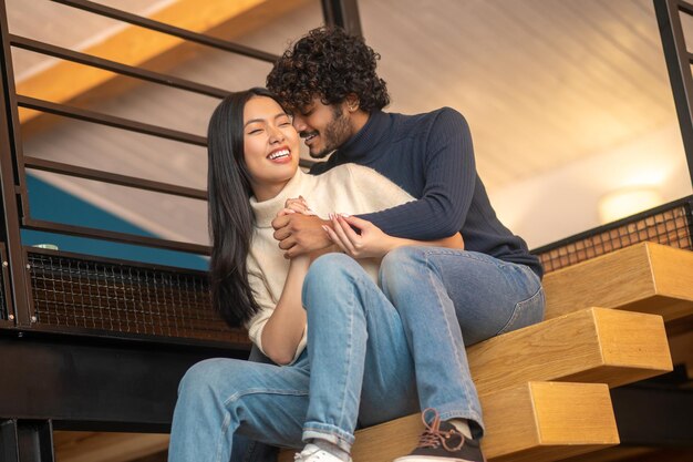 Man hugging whispering in ear of woman