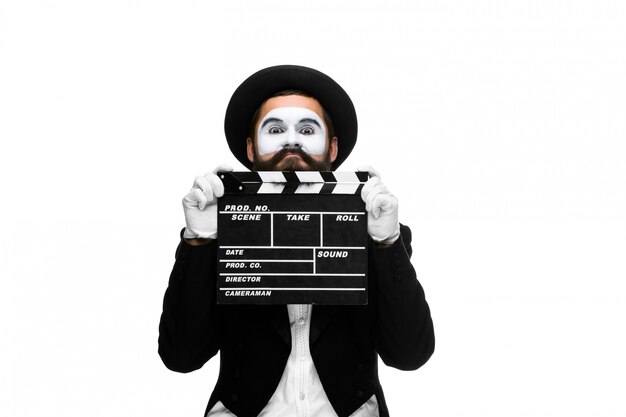 Free photo man in the image mime with movie board