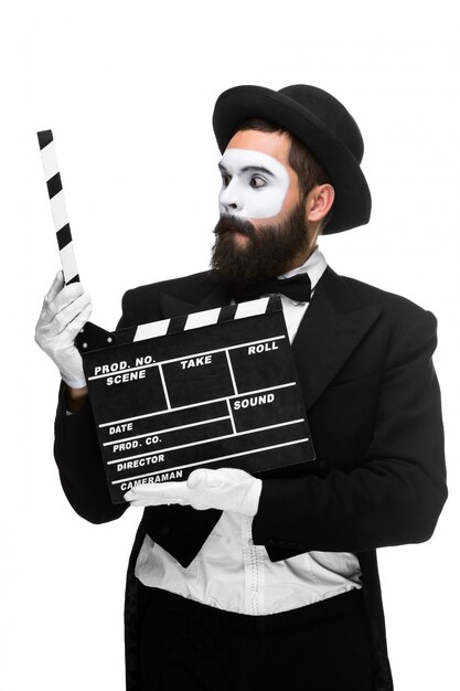 Man in the image mime with movie board