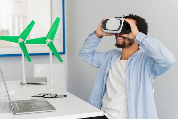 Free photo man innovating wind energy in virtual reality style