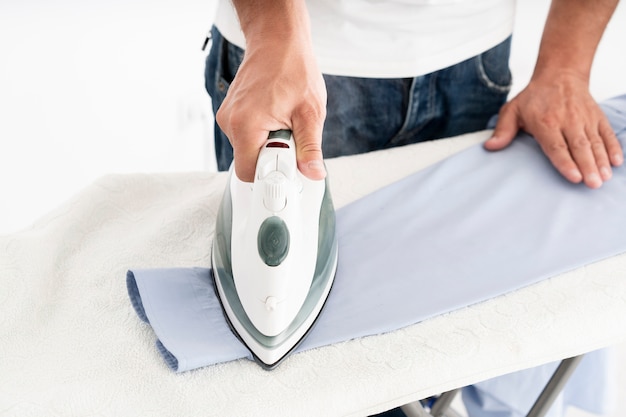 Man ironing suit shirt close up