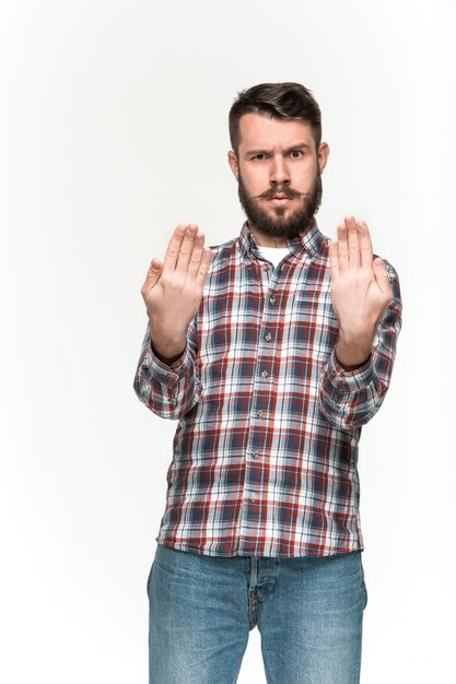 Man is looking serious. Over white wall