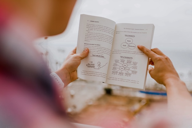 Man is reading a little book 