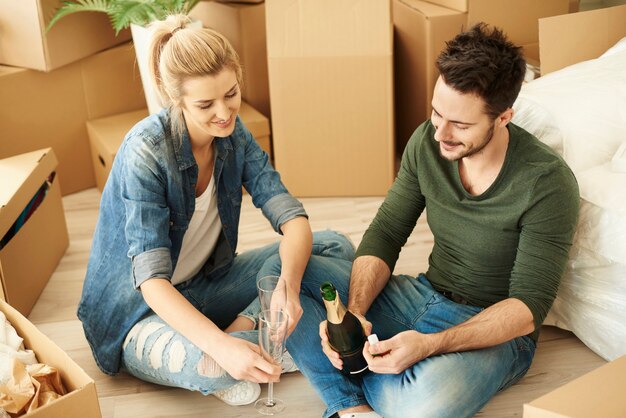 Man is ready to pour some champagne into glasses