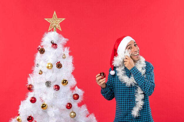 クリスマスツリーの横に男が立っています