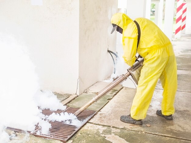 Man is using thermal fog machine to protect mosquito spreading