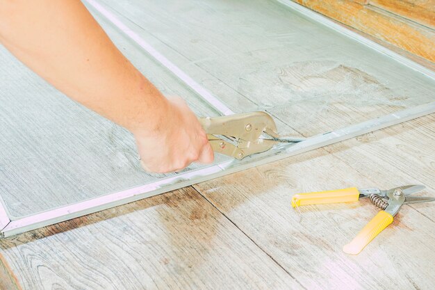 Man is working with mosquito wire screen installation