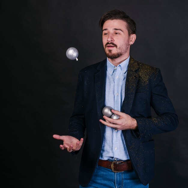 Man juggling with shiny baubles 