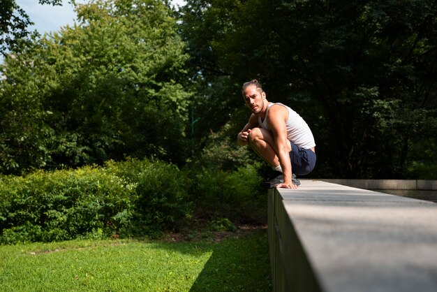 Man jumping over stone fence