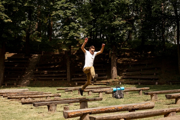 Man jumping over wooden benches