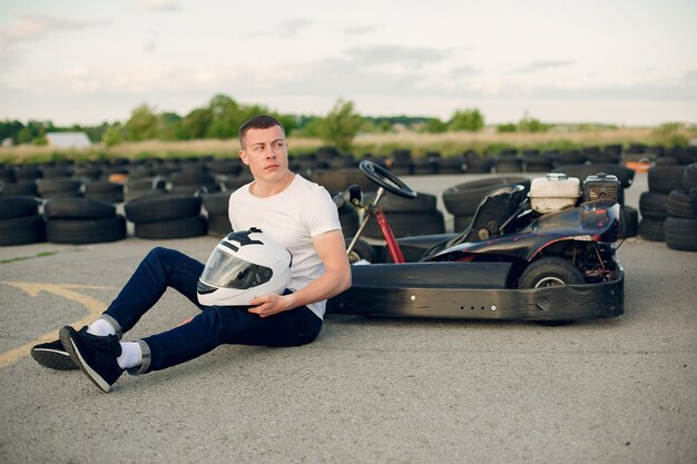 Man in a karting circuit with a car