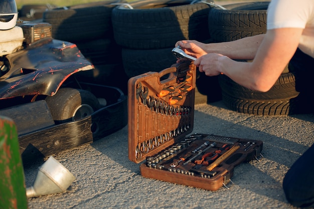 Free photo man in a karting circuit with a car