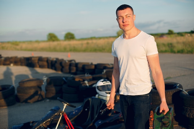 Man in a karting circuit with a car