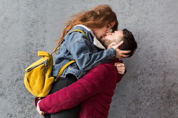 Man kissing his woman medium shot