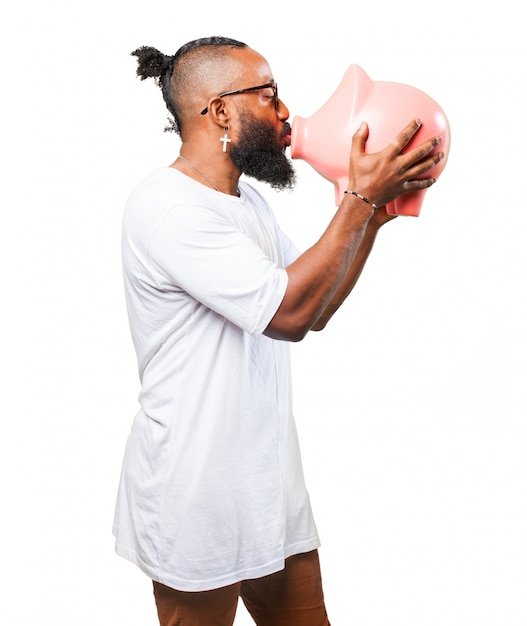 Man kissing a piggy bank