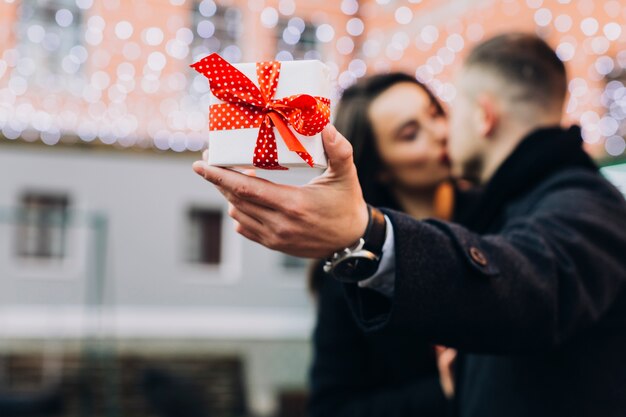 Man kissing with woman showing present