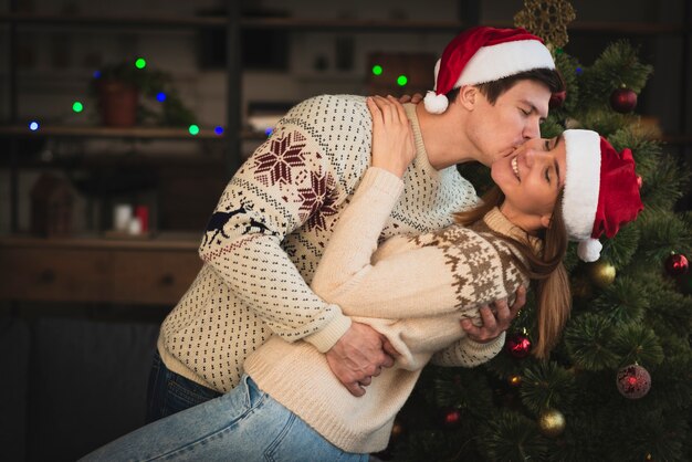 Man kissing woman on cheek