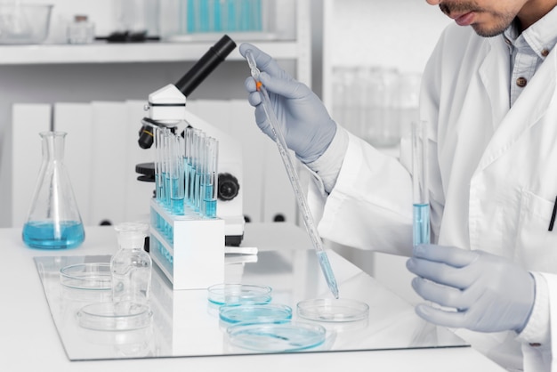 Man in lab working with microscope