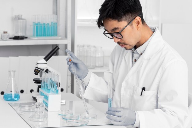 Man in lab working with microscope