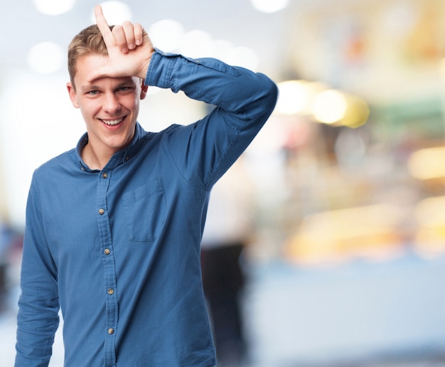 Man laughing with an l on his forehead