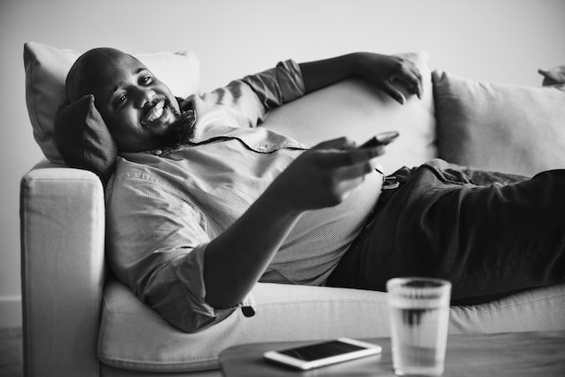 Man laying and relaxing on the couch